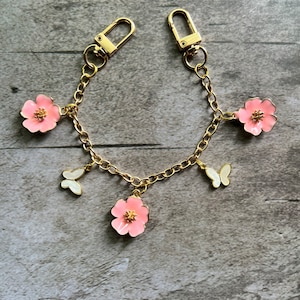 Purse charm on chain with flowers and butterflies