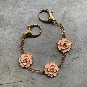 Purse charm with pink flowers