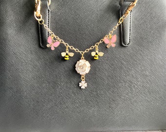 Purse charm on chain with flowers, bees and butterflies