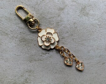 Flower charm with heart dangles