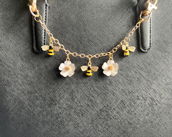 Purse charm on chain with flowers and bees