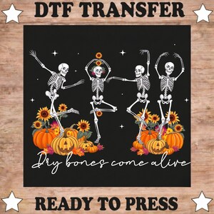 May include: A DTF transfer sheet featuring four white skeletons dancing among orange pumpkins and yellow sunflowers on a black background. The text reads DTF TRANSFER at the top, READY TO PRESS at the bottom, and Dry bones come alive in script.