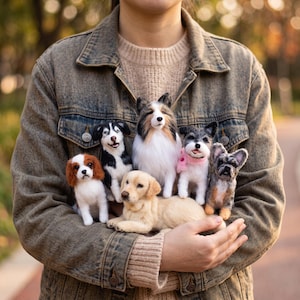May include: A collection of six needle-felted dog figurines featuring a variety of breeds including a golden retriever, a cavalier king charles spaniel, and a sheltie, all crafted with realistic textures and colours, displayed together in a group.