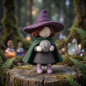 May include: A needle-felted doll wearing a purple pointed hat, a dark green cape, and a gray dress. The doll has reddish-brown hair, a featureless face, and light purple boots, and is holding a small gray ball of yarn in its hands.