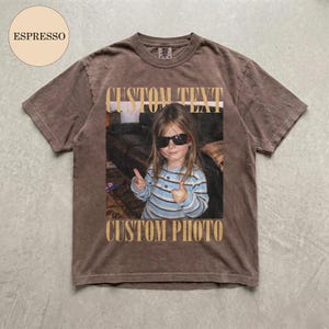 May include: A brown short-sleeve t-shirt featuring a central rectangular graphic of a child wearing sunglasses and a blue striped shirt, with the text CUSTOM TEXT above the image and CUSTOM PHOTO below it, and an ESPRESSO circle label.