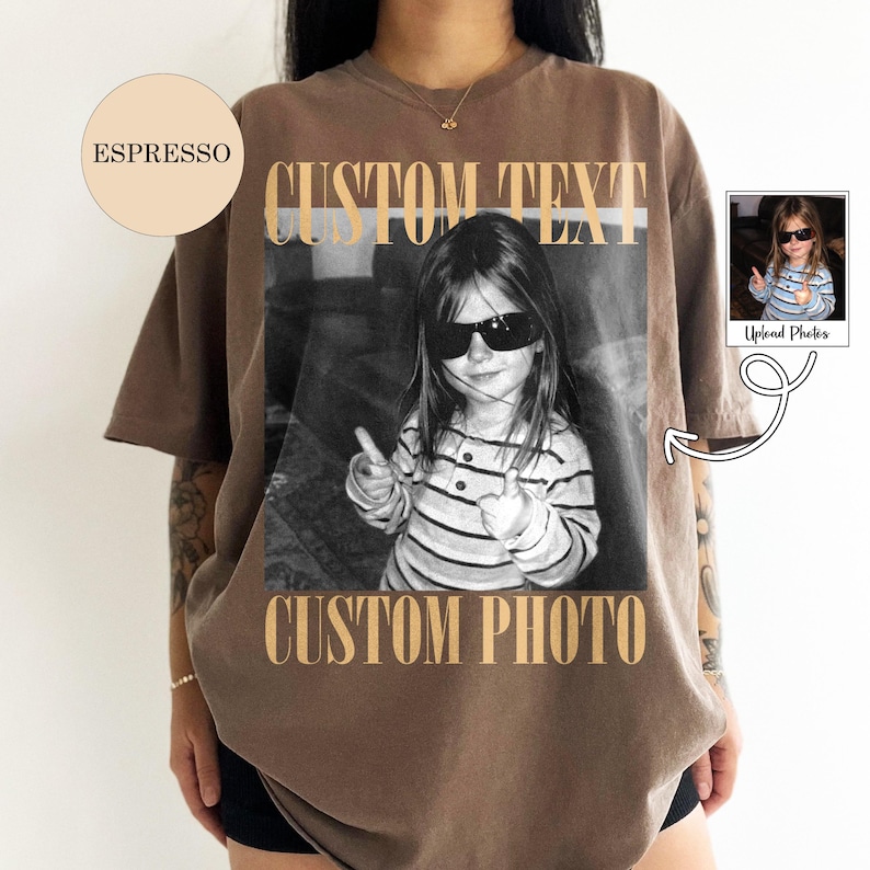 May include: An espresso-colored t-shirt featuring a black and white graphic of a child wearing sunglasses and a striped shirt. The text CUSTOM TEXT appears above the photo and CUSTOM PHOTO appears below the photo in a bold, tan, serif font.