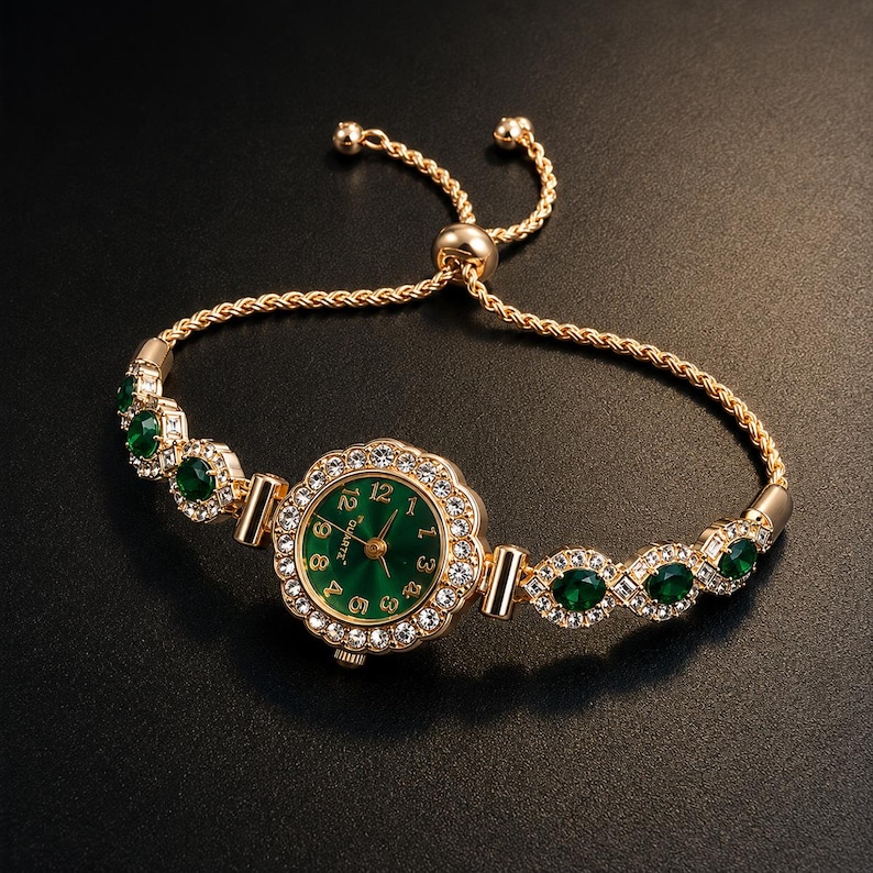May include: A gold-tone quartz watch with a round green face featuring gold numerals. The bezel is encrusted with clear crystals. The bracelet consists of alternating green oval stones and clear crystals, finished with a gold-tone rope chain.