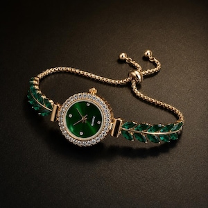 May include: A gold-tone quartz watch featuring a round green dial with small crystal hour markers. The bezel is encrusted with clear stones. The bracelet consists of gold-tone chains adorned with marquise-cut green leaves and an adjustable slider.