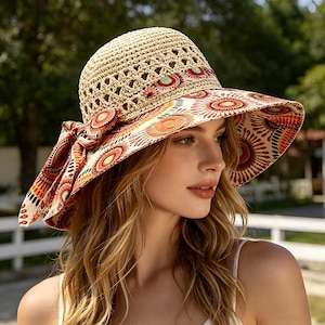 May include: A beige straw sun hat with a wide brim and a decorative band featuring a colourful circular pattern in red, orange, and yellow. The hat has a matching bow on the side.