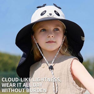 May include: A wide-brimmed sun hat featuring a white crown with a black and white panda face design, black ears on top, and a broad black brim. The hat includes a white and black adjustable chin strap with a black toggle for a secure fit.