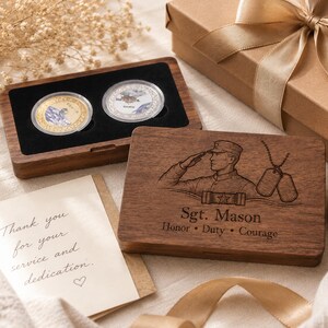 May include: A rectangular wooden box with a hinged lid engraved with a saluting soldier, dog tags, and the text Sgt. Mason, Honor, Duty, Courage. Inside are two circular coins in a black velvet insert, accompanied by a card reading Thank you for your service and dedication.