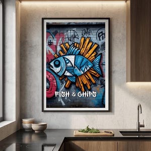 Könnte beinhalten: Gerahmter Kunstdruck mit einer Graffiti-Illustration eines blau-weißen Fisches mit orangefarbenen Pommes Frites. Der Schriftzug "FISH & CHIPS" ist weiß. Der Hintergrund ist eine Backsteinmauer mit bunten Graffiti.