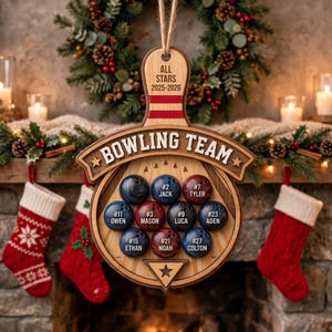 May include: A wooden bowling team ornament featuring a pin-shaped top with the text ALL STARS 2025-2026 and a circular base labeled BOWLING TEAM. It displays nine round bowling ball inserts, each printed with a unique player number and name.