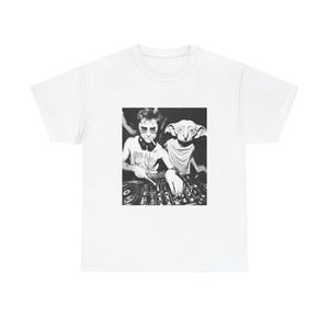 May include: White t-shirt featuring a black and white image of two figures operating DJ equipment. One figure wears sunglasses and headphones, the other has large ears. The shirt has a crew neck and short sleeves.