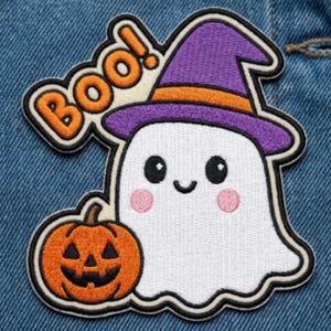 May include: An embroidered patch featuring a white ghost with pink cheeks wearing a purple witch hat with an orange band. Next to the ghost is an orange jack-o'-lantern with a black face. The word BOO! is embroidered in orange above the ghost.