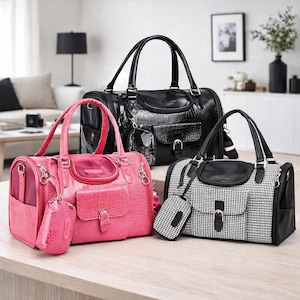 May include: Three pet carrier bags in black, pink, and black and white houndstooth patterns. The bags have top handles, small front pockets, and matching accessories. The pink bag has a crocodile texture.