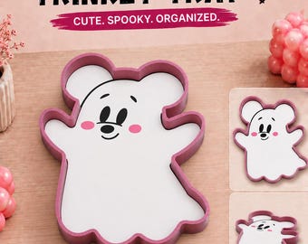 May include: A mouse ghost trinket tray with a white center and a pink border. The tray features a cartoon mouse ghost face with black eyes, a nose, and pink cheeks. Text reads: MOUSE GHOST TRINKET TRAY, CUTE. SPOOKY. ORGANIZED., STL FILE READY TO PRINT, 3MF FILE READY TO PRINT.