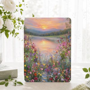 May include: A rectangular tablet case featuring an oil painting print of a sunset over a calm lake surrounded by rolling hills and a vibrant foreground of colorful wildflowers in shades of pink, purple, yellow, and red with visible brushstrokes.