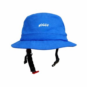 May include: A vibrant blue bucket hat featuring the word "NOGGY" in white. It has a black strap and buckle. The hat is designed to be worn on the head.