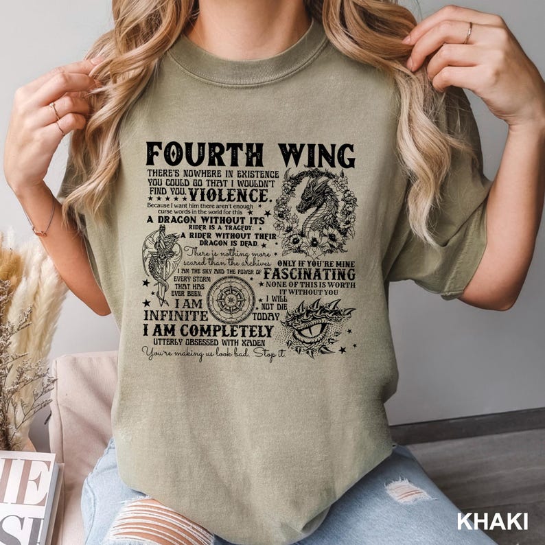 May include: Khaki-colored t-shirt featuring the text "Fourth Wing" and various quotes and graphics, including a dragon and eye. The shirt's design incorporates phrases like "Violence" and "Fascinating."