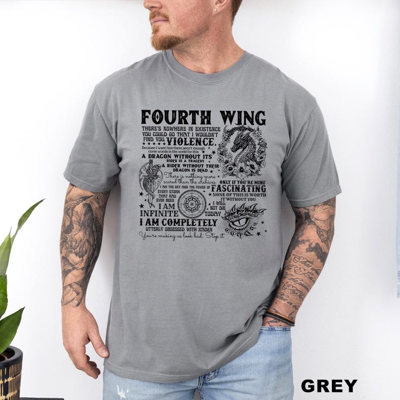 May include: Grey t-shirt with the text "FOURTH WING" and other text and graphics. The shirt features a dragon illustration and various phrases. The word "GREY" is printed at the bottom right.