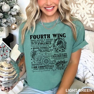 May include: Light green t-shirt with the text "FOURTH WING" and a dragon graphic. The shirt features a quote about dragons and violence. The shirt is a light green color.