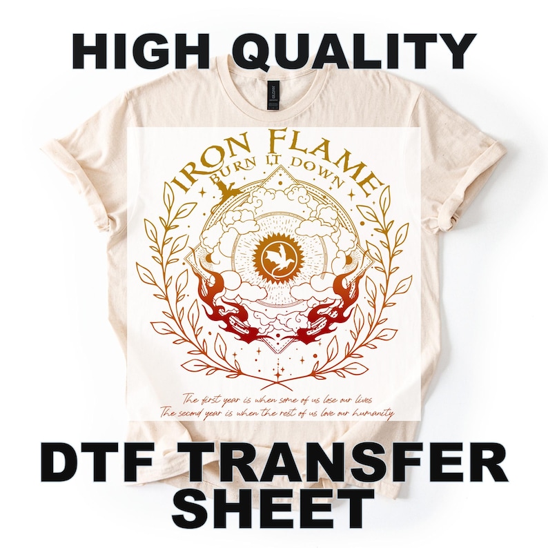 May include: A cream-colored t-shirt with a DTF transfer sheet design. The design features the text "IRON FLAME BURN IT DOWN" in a circular pattern with a central emblem and flame accents. The shirt also has the text "HIGH QUALITY" and "DTF TRANSFER SHEET".