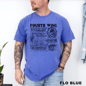 May include: A blue t-shirt with the text "FOURTH WING" and a dragon graphic. The shirt has additional text with phrases like "A dragon without its rider is a tragedy" and "I am completely utterly obsessed with Xaden."