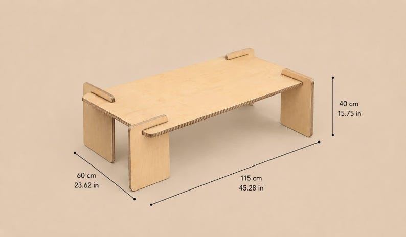 May include: A light-colored wooden table with a rectangular top and four flat legs. The table features visible joinery where the legs slot into the top. Dimensions are 15.75 inches high, 23.62 inches wide, and 45.28 inches long as indicated.