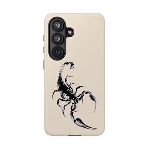 May include: A beige smartphone case featuring a detailed black and white illustration of a scorpion. The design shows the scorpion with its tail arched upward, positioned centrally on the back of the case, which has three camera lenses.