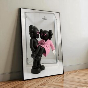 May include: A black framed mirror featuring two KAWS Companion figures. One figure is holding the other, who is wearing a pink robe. The figures have black bodies with pink XX eyes. The mirror reflects a shower.