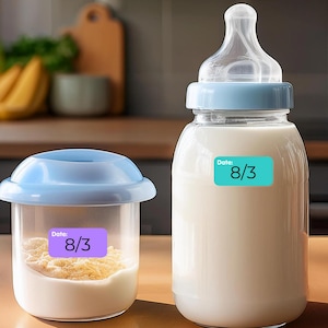 May include: Two blue and white containers with labels that say "Date: 8/3". One container is a baby bottle filled with milk and the other is a smaller container with a white substance inside.
