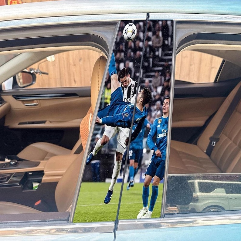May include: Car window decals featuring a soccer player in mid-air kicking a soccer ball. The player is wearing a blue uniform. The background shows a soccer stadium and other players.