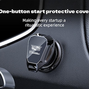 Op de afbeelding: Een zwarte Cadillac beschermhoes voor de startknop. De hoes heeft een zilveren Cadillac-logo en tekst. De tekst "One-button start protective cover" en "Making every startup a ritualistic experience" zijn ook zichtbaar.