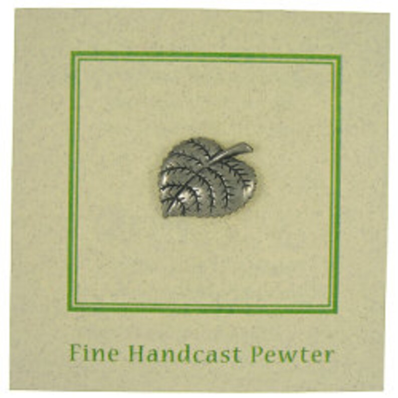 May include: A small, silver-colored pewter leaf pin. The pin is in the shape of a leaf with detailed veining. It is displayed on a cream-colored card with a green border. The text "Fine Handcast Pewter" is printed at the bottom.