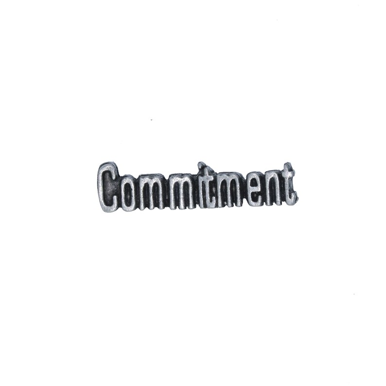 May include: Silver charm with the word "Commitment" spelled out in raised letters.