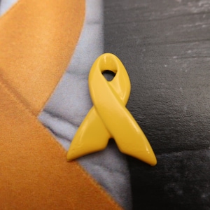 Yellow Ribbon Pin- Raise Awareness for Adoption, Bladder and Liver Cancer, Endometriosis, Hope, Hunger, Military, and Suicide Prevention image 1