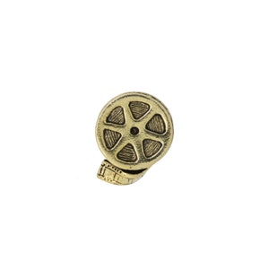 May include: A gold-colored metal film reel charm with a detailed design. The reel is partially wound with film.