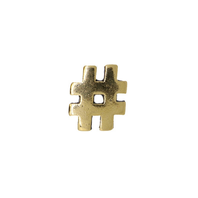 May include: A gold-colored metal hashtag symbol.