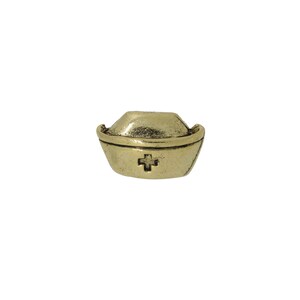 May include: Gold-toned metal nurse's cap charm with a red cross in the center.
