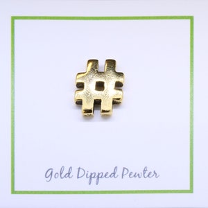 May include: Gold-dipped pewter charm in the shape of a hashtag symbol. The charm is on a white card with the text "Gold Dipped Pewter".