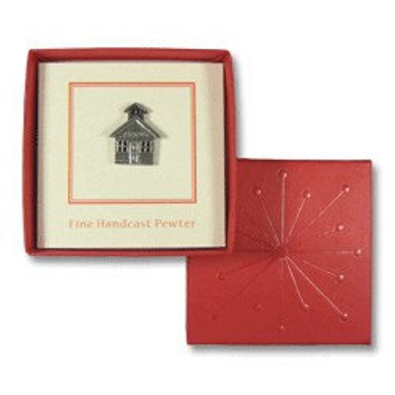 May include: A small pewter schoolhouse figurine in a red box with the words "Fine Handcast Pewter".