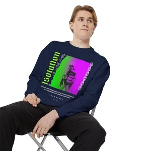 May include: Navy blue sweatshirt with a neon green and pink graphic that says "Isolation". The graphic features a stylized image of a person and a chain design. The sweatshirt has long sleeves.
