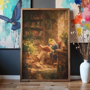 May include: A framed oil painting depicting a frog dressed in a suit sitting in a chair and reading a book within a library setting. The artwork features warm brown and green tones, with visible brushstrokes and a detailed scene of bookshelves.