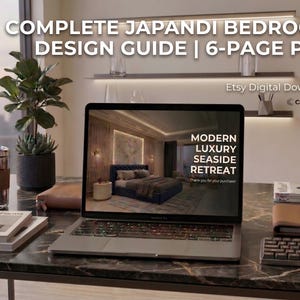 May include: A laptop showing a bedroom design with the text "MODERN LUXURY SEASIDE RETREAT" sits on a desk with a plant, books, and a coffee tumbler. The text "COMPLETE JAPANDI BEDROOM DESIGN GUIDE | 6-PAGE PDF" is at the top.