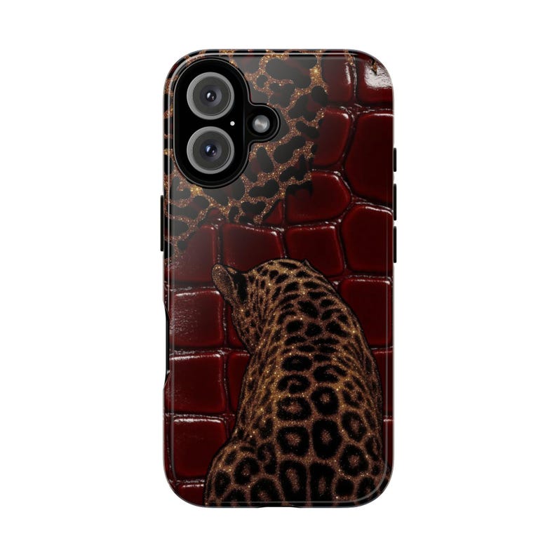May include: A phone case featuring a dark red, textured background with a leopard design. The leopard is brown with black spots and is facing away from the viewer. The case has a black border and a camera cutout.