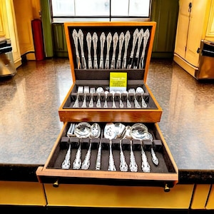 May include: A set of three ceramic mugs with a speckled, matte finish. The mugs are in shades of cream, light gray, and dark gray. Each mug has a simple, minimalist design, perfect for coffee or tea.