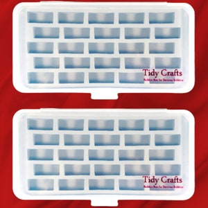 May include: Two white plastic storage boxes with clear compartments. Each box has a label that reads "Tidy Crafts" and "Bobbin Box for Sewing Bobbins".