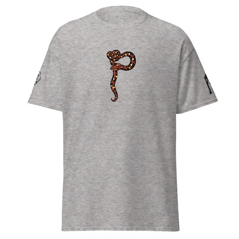 May include: A grey t-shirt with a snake design in brown, orange, and black. The snake is coiled and has a long, curved body. The shirt has short sleeves and a crew neck.