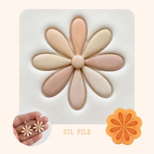 May include: A daisy-shaped design in shades of beige, pink, and white. The image includes a pair of daisy earrings, a daisy-shaped cookie cutter, and the text "STL FILE".